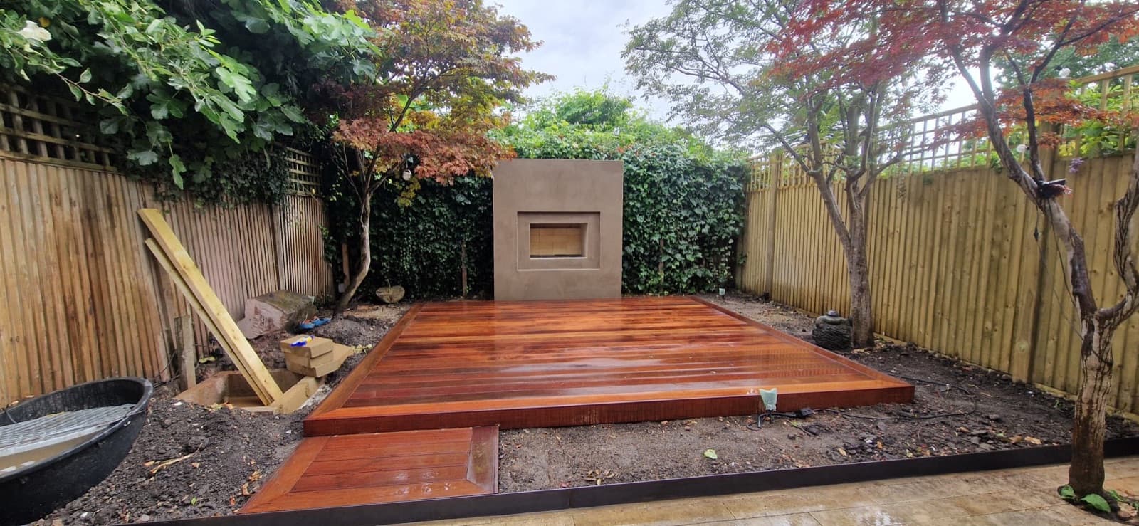 Timber deck with a rendered water feature and Japanese maple