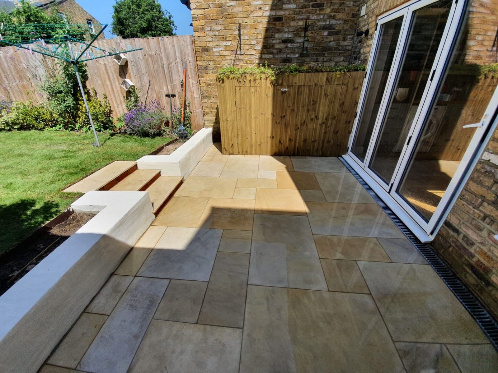 French pattern Sandstone-paved area with a timber storage shed and living roof