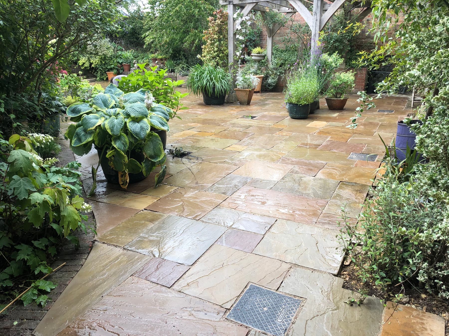 Potted topiary along a sandstone garden path
